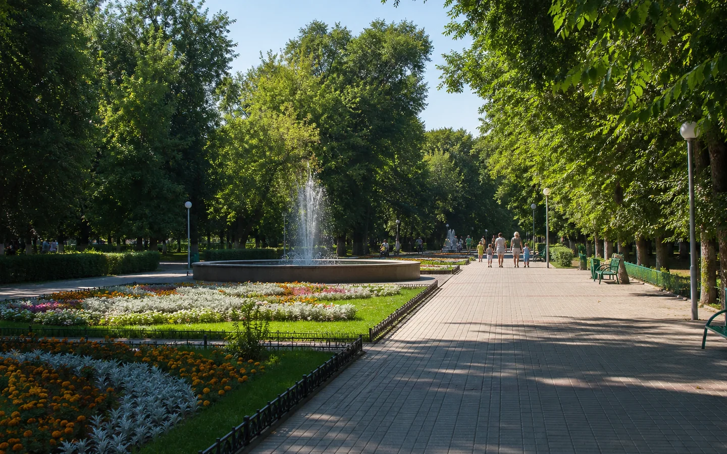 Тенистая аллея с цветниками и фонтаном в парке Поддубного в Ейске